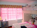 Sheer drapes along with a straight cornice for kids bedroom in New York City